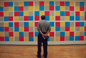 A visitor observes one of Sol LeWitt’s wall drawings at the Mass. Museum of Contemporary Art.
