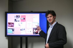 Alex Clark shows off a prototype of his novel LCD interactive flyer board, which will soon appear in Bass.