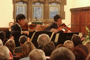 Kensho Watanabe ’09 (R) and Kisho Watanabe ’11 (L) perform a “musical interlude” in the Great Hall (the dining hall, in other words) at JE’s rededication ceremony. The piece was for violin and viola.