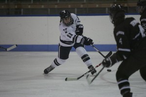 Forward Aleca Hughes ’12 takes a shot in the Elis’ 4-1 victory over Brown in their first ECAC home game Dec. 4.