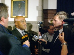 Tom Williams is surrounded by news reporters after being introduced as Yale's next head football coach.