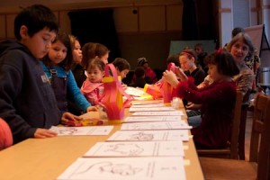 Children at the Neighborhood Music School craft lanterns at an event celebrating the Chinese New Year.