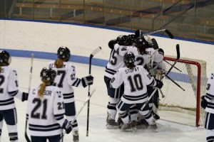 The women’s hockey team celebrates its 3-1 victory over the Cornell Big Red at Ingalls Rinks on Saturday.