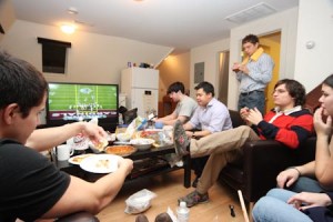 Students enjoy pizza and snacks while watching Super Bowl XLIII at the Sigma Chi house on Sunday.