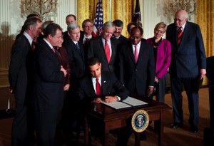 Yale Chief Investment Officer David Swensen (far left) looks on as President Barack Obama signs an executive order in the East Room of the White House on Friday. Obama and Economic Advisory Chair Paul Volcker held the event to introduce members of the President's Economic Recovery Advisory Board, of which Swensen was named a member.