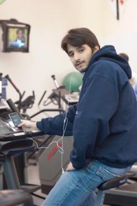Henrique Rocha ’09 demonstrates his senior project, an exercise bike that can charge the user’s cell phone.