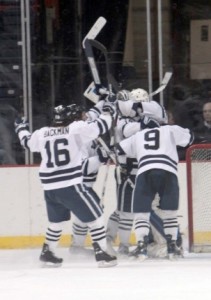 The Yale men's hockey team celebrates its win over St. Lawrence in the ECAC seminfinals on Friday. The top-seeded Bulldogs will face Cornell on Saturday in the ECAC tournament championship game.