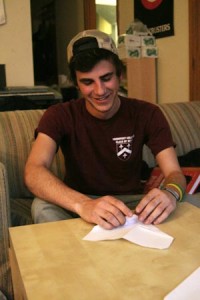 Jack Hart ’12 demonstrates his signature paper airplane design, which triumphed in two categories of the Red Bull competition.