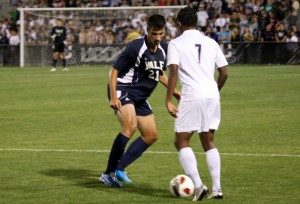 Defender Milan Tica ’13 tries to stop UConn’s Qian Grosvenor. The Elis fell in their season opener, 3–1.