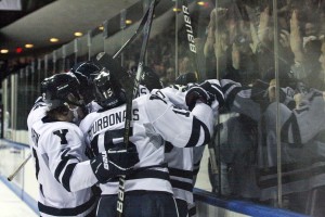 The No. 1 men’s hockey team celebrates a goal in front of the student section on Friday night. After going 2–0 over the weekend, the team is now 12–0 in front of its home crowd this season.