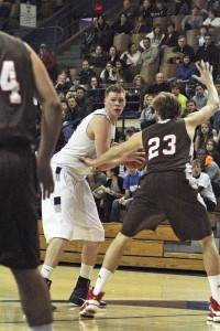Center Greg Mangano ’12 goes up for a layup over two Brown defenders. The junior has recorded four consecutive double-doubles.