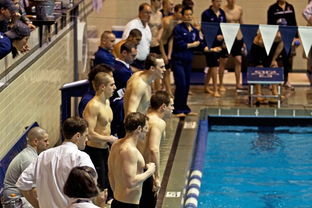 Members of the men’s swimming team cheer on their teammates at the annual Harvard-Yale-Princeton meet last weekend. The Bulldogs lost to Harvard 266–87 and Princeton 238–115.