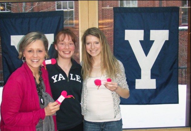 Mary Ann Wasil Nilan, Steph Madner ’11 and McLane Ritzel holding pink laces.