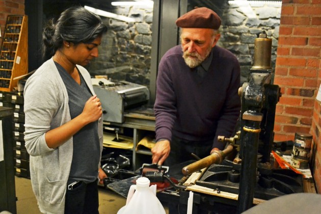 Leslie Smith ’70 assists a student in the Davenport Book Arts Center, which holds four printing workshops each week.