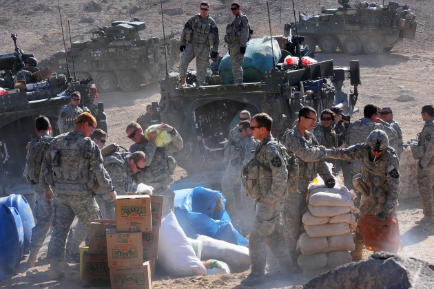 U.S. soliders distribute food and humanitarian aid to an Afghan village. A new Yale study has food aid is correlated with increased levels of civil war.