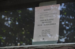 Notices have been posted to the buildings behind the Grove Street Cemetery that are slated for demolition.