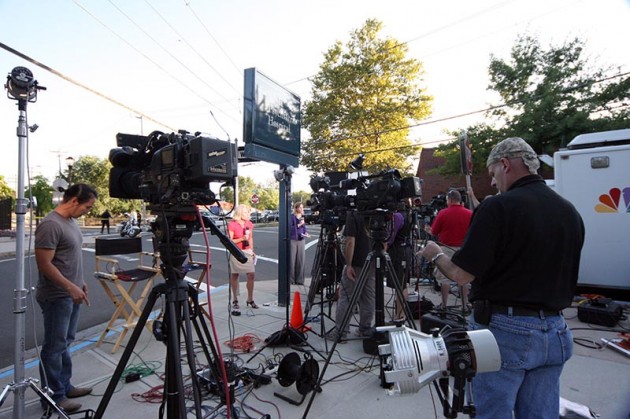 Television stations and newscasters set up around 10 Amistad St. on Sept. 14.