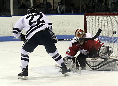 Brendan Mason '11 slaps a successful shot against St. Lawrence. The Bulldogs won 7–5.