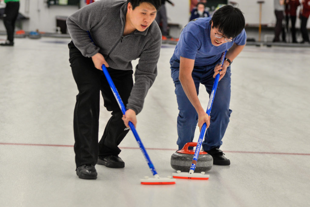 Patrick Huang and Dennis Wang sweeping. Courtesy of Joseph Cosentino.