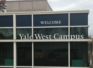 A sign saying "Yale West Campus" on a building on Yale