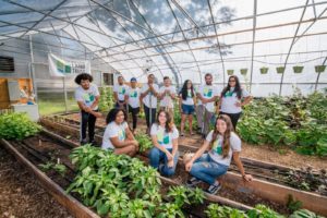 New Haven Land Trust volunteers pose for a photo in a greenhouse pre-pandemic.