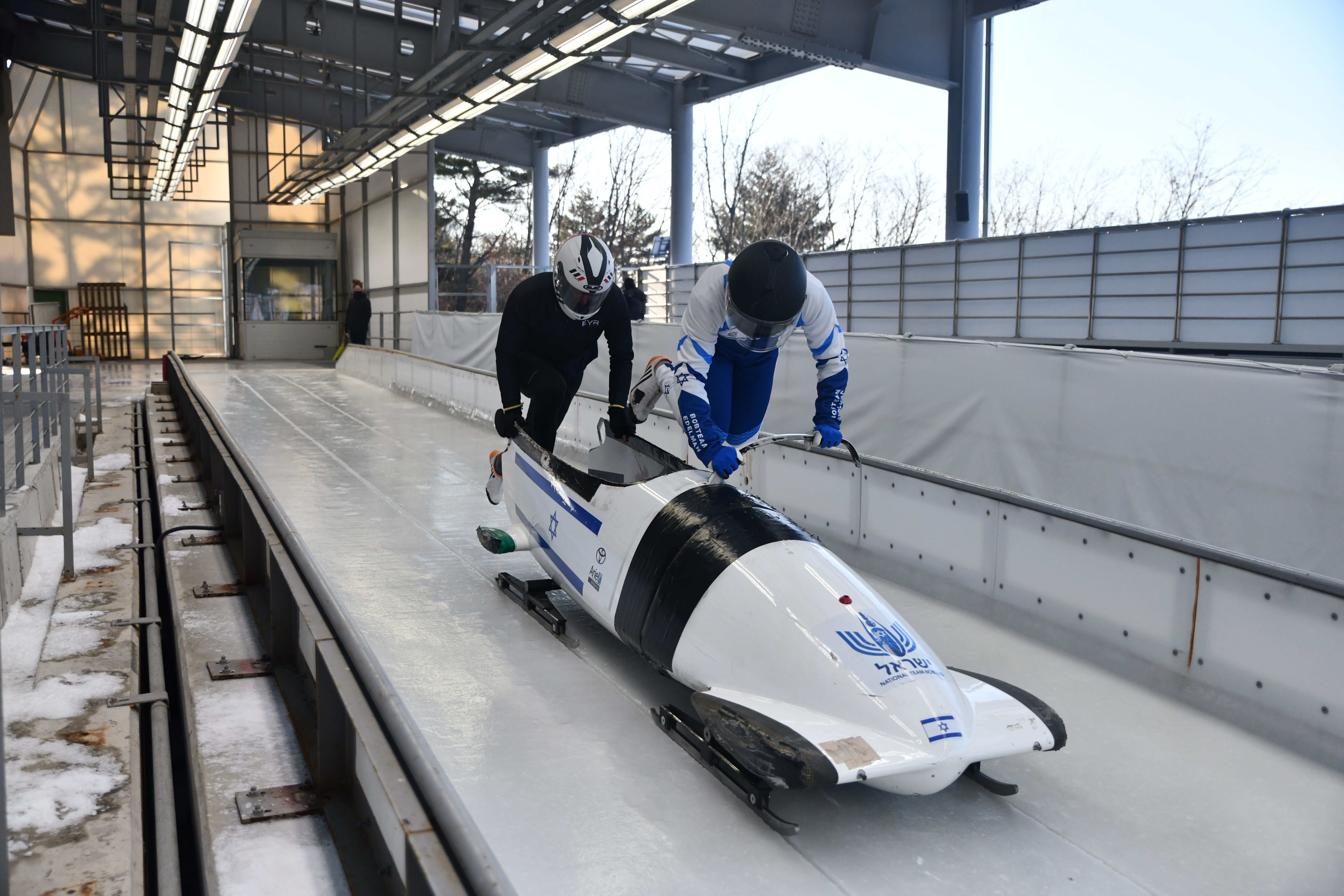 A photo of Edelman and a teammate getting into a bobsled
