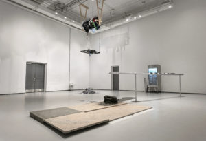 A photo of an art installation by Saejun Jeenho involving a shredder of Korean clothes hanging from the ceiling