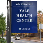 An up close of the sign of the Yale Health Center.