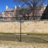 The black chain link fence standing in front of Berkeley North Court on Cross Campus on a sunny day.