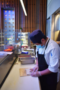 A chef at the Ground Cafe makes sushi.