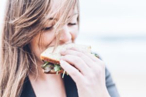 A woman smelling a sandwich