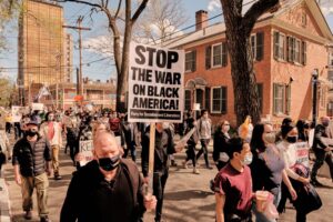 Protesters march east on Wall St. in between Silliman and Slifka.