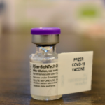 A close-up of a vial of the Pfizer COVID vaccine.