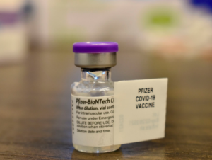 A close-up of a vial of the Pfizer COVID vaccine.