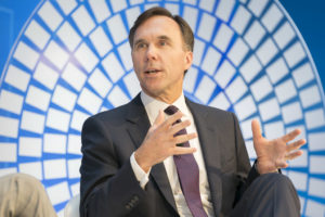 Morneau gives a talk in front of a blue and white background.