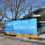 A sign welcoming people to a YNHHS vaccine site