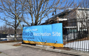 A sign welcoming people to a YNHHS vaccine site
