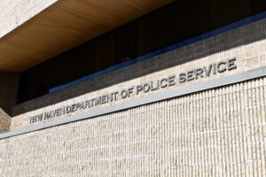 An up close photo of the sign on the front of NHPD headquarters