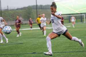 A Yale soccer player strikes a ball in a home match.