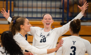 Yale volleyball players celebrate after a point