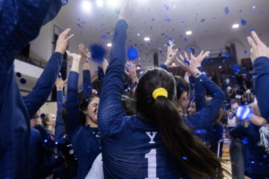 The Yale volleyball team celebrates their 2019 title win.