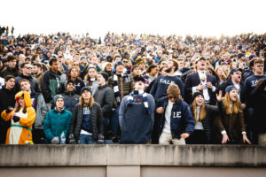 Yalies cheer on the football team at the Yale Bowl.